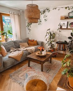 a living room filled with furniture and lots of plants