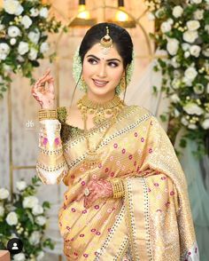 a woman in a yellow sari posing for the camera