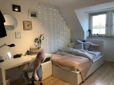 a bed room with a neatly made bed and a desk in front of a window