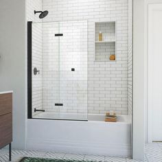 a white tiled bathroom with a walk in shower