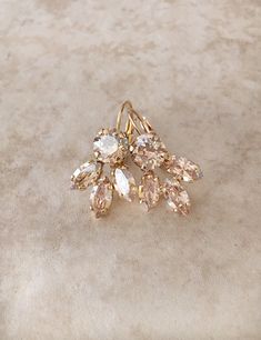 "Gorgeous pair of leaf earrings featuring sparkling champagne crystals. Available in Rose gold, silver or gold plated settings. Please select desired metal finish from the drop down menu at check out. From ear piercing, the earrings are 1 1/4 \" long and 5/8\" wide. The rhinestone cluster portion of the earring is 3/4\" long by 5/8\" wide. Thanks for stopping by." Champagne Earrings, Earring Bridal, Leaf Earring, Crystal Teardrop Earrings, Jewelry Bridesmaid, Earrings Crystal, Name Jewelry, Swarovski Crystal Earrings, Wedding Jewelry Earrings