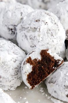 a pile of powdered donuts sitting on top of a white plate