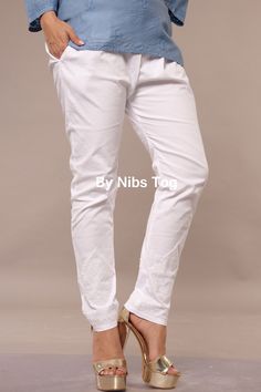 Nibs Tog Lucknowi Chikankari Lycra Cotton Stretchable Pant White Intricate Embroidered Chikankari Pant, Stretchable and comfortable fit. The pant includes pocket and had ankle length with straight regular fit. You can easily move n sit comfortable wearing the pant. Team up the pant with any chikankari or other Indian kurta or short kurta as well. Features: Fabric: The lucknowi Pant is made of Cotton Lycra fabric which completely stretchable. The fabric is breathable and comfortable to wear for longer duration. It is soft, smooth and skin friendly. Style: The Chikankari Bottom wear pant is made in straight regular fit style. it has elasticated belt from back and also includes drawstring for waist adjustment as per your body fit. The pant has standard Ankle length.  It has beautiful chikanka Traditional White Bottoms, Traditional Cotton Straight Leg Bottoms, Traditional Straight Leg Cotton Bottoms, Traditional White Long Pants, Casual Straight Pants With Chikankari Embroidery, Traditional White Bottoms With Floral Embroidery, Traditional Trousers With Chikankari Embroidery, Traditional White Straight Pants, Traditional Embroidered Cotton Bottoms