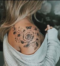 a woman with a flower tattoo on her shoulder