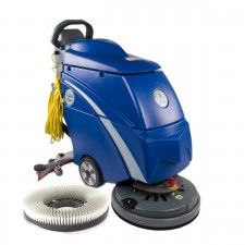 a blue floor scruber sitting on top of a white surface next to a brush