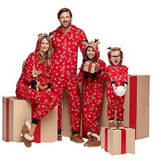 a man and two women in matching red pajamas