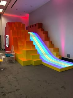 an indoor play area with slides and chairs