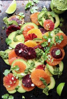 an assortment of fruits and veggies on a baking sheet with avocado