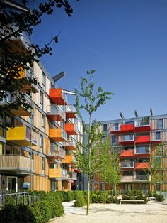 an apartment building with multiple balconies and colorful balconies on the sides