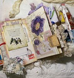 an altered book with flowers and lace on it