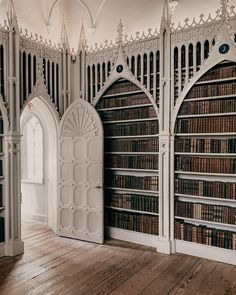 an old library with wooden floors and white walls