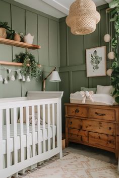 a baby's room with green walls and white crib in the corner, potted plants on shelves