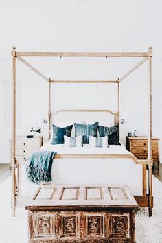 a bedroom with a canopy bed and white walls