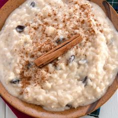 a bowl filled with oatmeal and cinnamon on top of a plaid table cloth