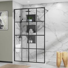 a bathroom with marble walls and flooring, including an open glass shower door in the center