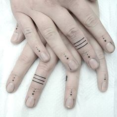 two hands with black dots on their fingers