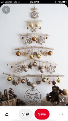 a christmas tree with ornaments hanging from it's sides and the words merry written below