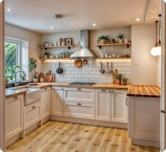 a kitchen with wooden floors and white cabinets