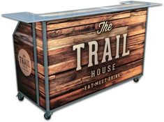 a large wooden box with the words the trail house on it's front and side