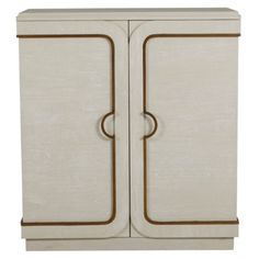 a white cabinet with two doors and brown handles