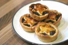 four mini pies on a white plate