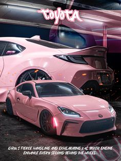 two pink sports cars parked next to each other in front of a neon sign that says toyota