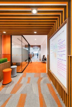 an office with orange and white walls and carpet