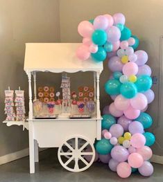 an ice cream cart with balloons and candy