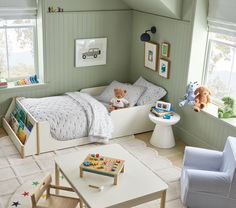 a child's bedroom with green walls and white furniture, including a toy bed