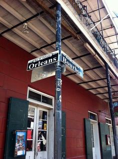 a street sign on the corner of orleans and bourbon