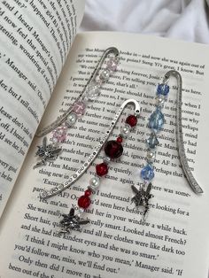 an open book with some charms on it