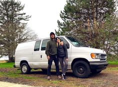 two people standing in front of a white van