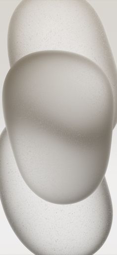 an abstract white object with three smaller objects in the background