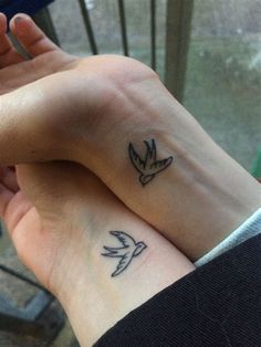 two people with matching tattoos on their wrists