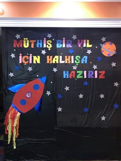 a bulletin board with a rocket and stars on it