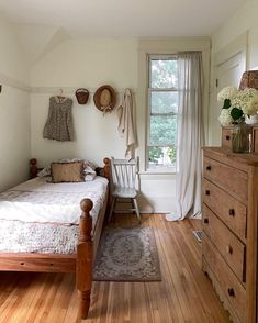 a bedroom with wooden floors and white walls