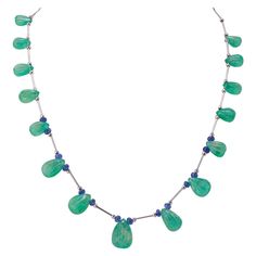 This special piece will never go out of style and will make you feel more gorgeous. From the boardroom to the ballroom, this necklace will make heads turn! This necklace is around 21 inches long. Stone Details: Emerald Carving Drop: 75.32 Carats Tanzanite Beads: 6.54 Carats 18K White Gold Zelda Au, Tanzanite Beads, Necklace Art Deco, Tanzanite Necklace, Elegant Jewellery, Necklace Art, Drop Beads, Knot Necklace, Drop Necklace