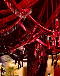 Luxurious red velvet drapes hang from the ceiling, draping the room in opulence and warmth. Sparkling crystal accents elevate the mood, reflecting the joy of the occasion. Lighting the table with lotus’s and red floral cascade. “Marsala” For Rachna & Saket Design & Decor : @abhinavbhagat87 @abhinavbhagatevents Catering : @divarestaurants @ritudal Production: @art._weddings Lighting & Technicals : @lightingbytechnocraft Rentals : @houseoffurniture97 @luxury.rental @sunny.dua.1232 @aakarfur... Hanging Fabric From Ceiling, Red Velvet Drapes, Floral Cascade, Hotel Canopy, Royal Decorations, Cocktail Decoration, Ceiling Draping, Crystal Curtains, Red Drapes