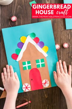 someone making a gingerbread house craft with paper