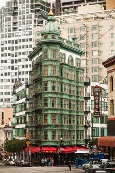 a large green building sitting on the side of a road