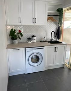 a washer sitting inside of a kitchen next to a window