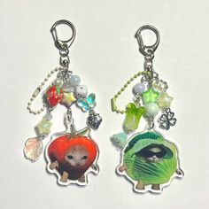 two key chains that have pictures on them