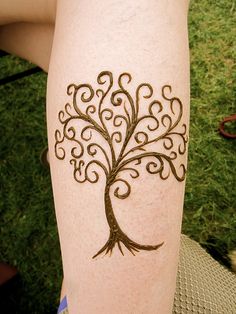 a woman's leg with a tattoo on it that is shaped like a tree