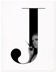 a girl holding a pair of scissors in front of a letter j