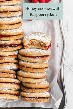 honey cookies with raspberry jam are stacked on top of each other