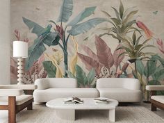 the living room is decorated with tropical wallpaper and white furniture, including two sofas