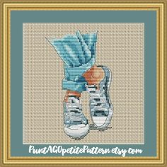 a cross - stitch picture of a pair of sneakers with blue socks and orange socks