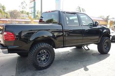 a black pickup truck parked in a parking lot