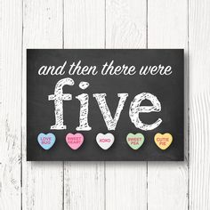 a chalkboard sign that says and then there were five with candy hearts on it