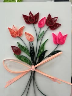 a card with flowers made out of paper